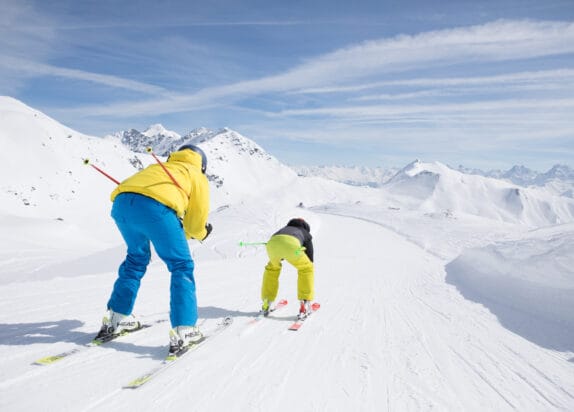 Fiss ski resort, two men skiing downhill