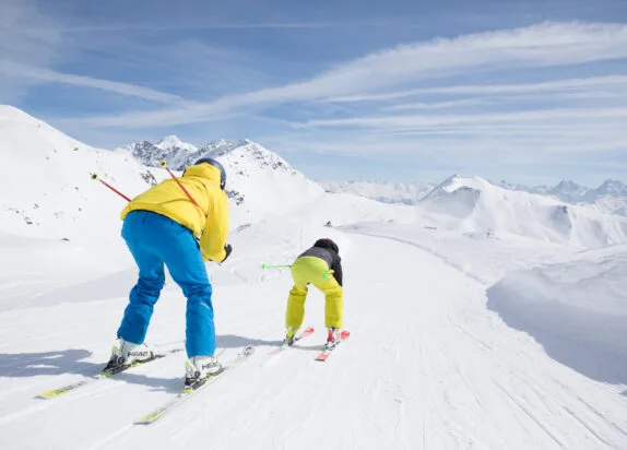 Fiss ski resort, two men skiing downhill